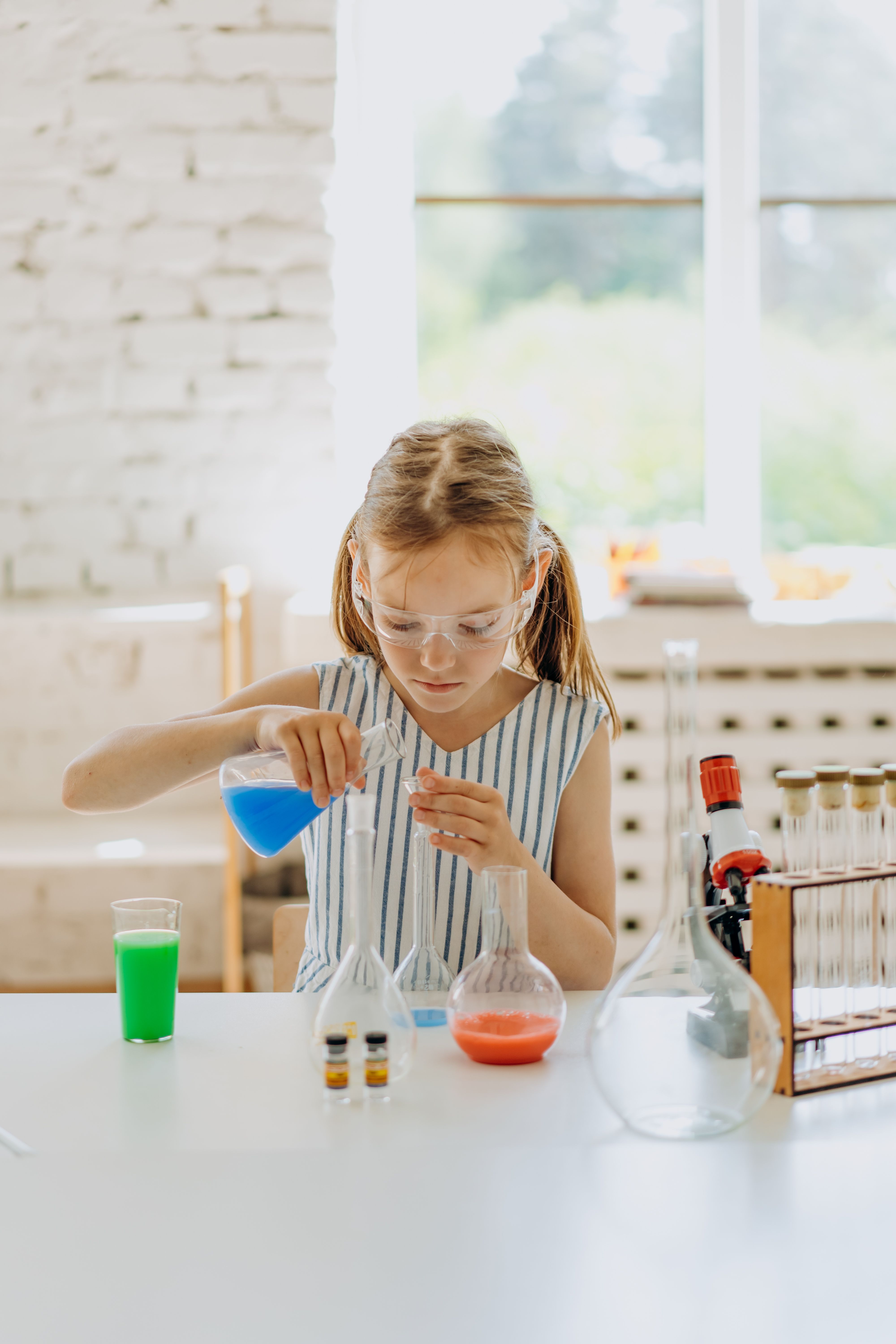 A child wearing safety goggles conducting a hands-on science experiment